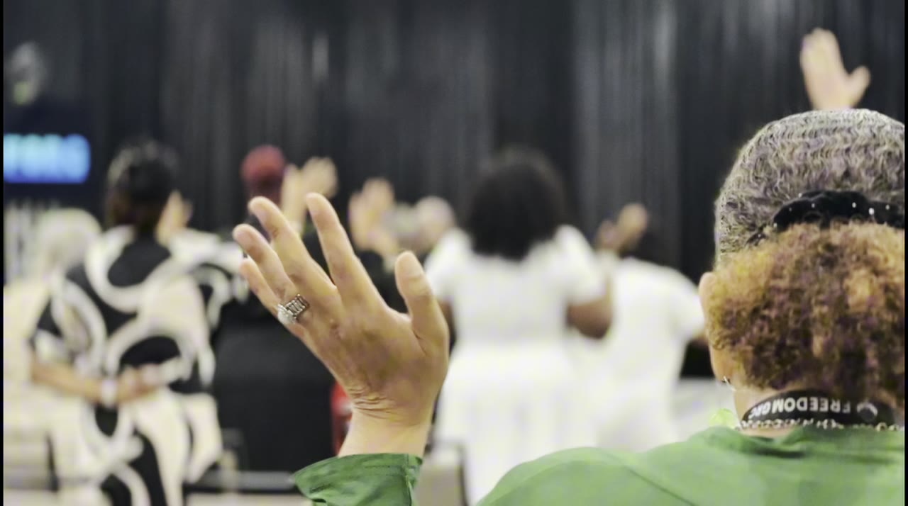 Worshippers with hands raised at the 2025 FreedomGRC Convention