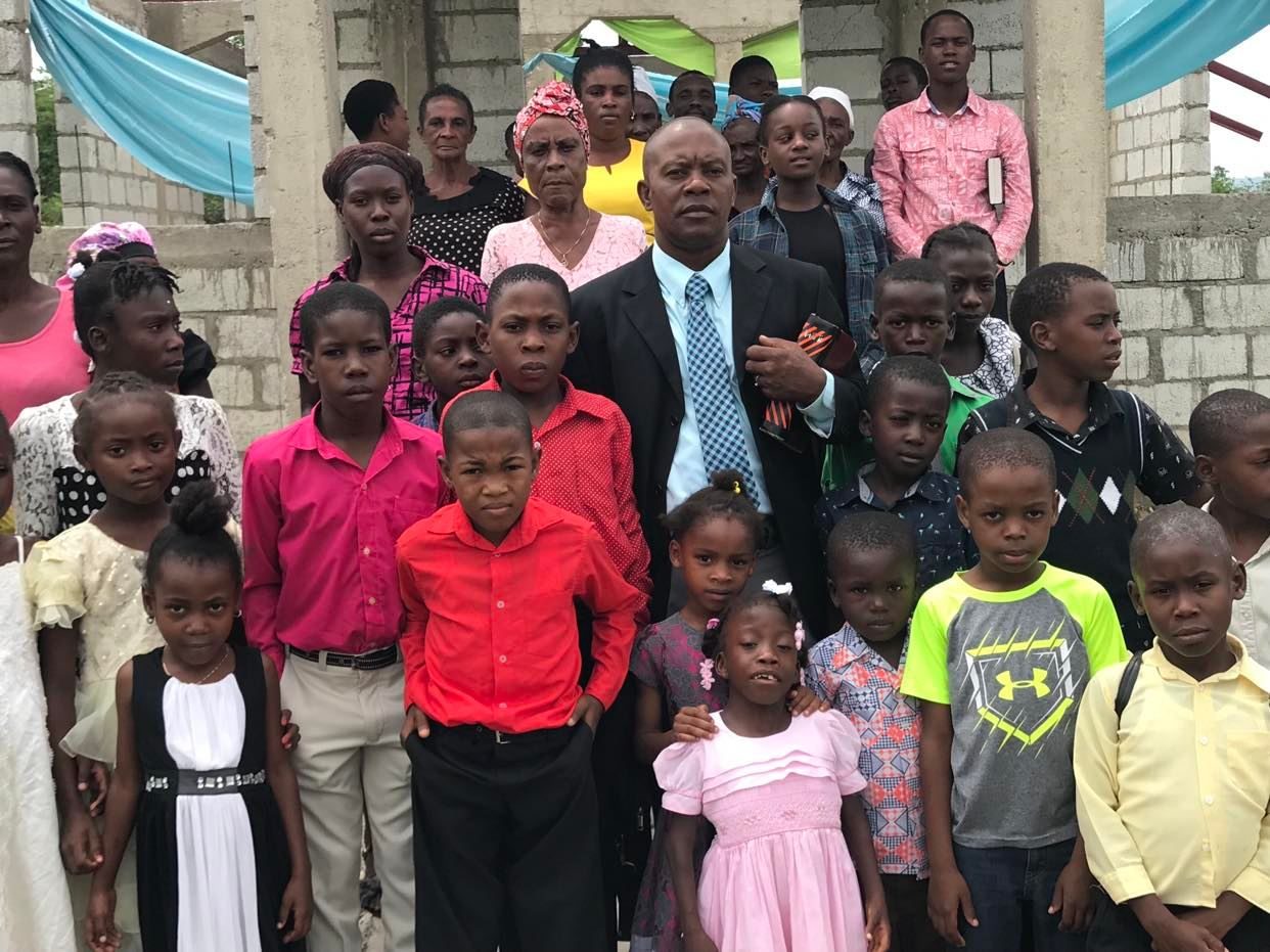 Mission leaders with children in the community